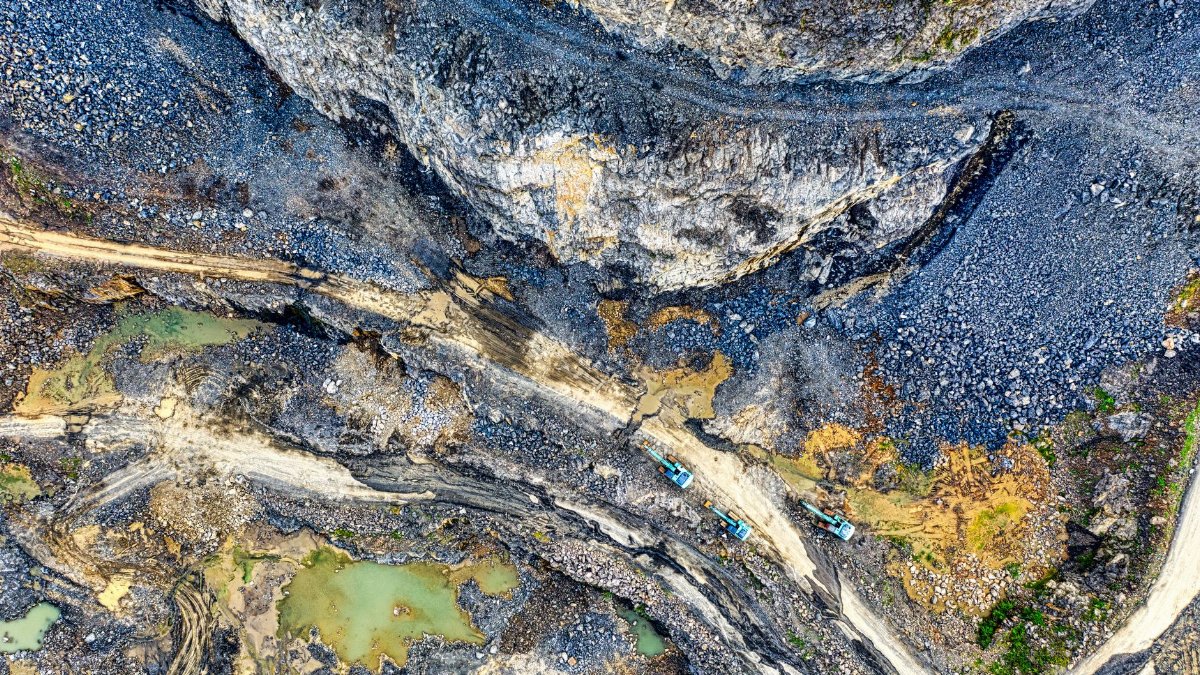 Aerial view of a quarry with excavators at work in West Java, Indonesia.