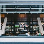 Open-air Toronto restaurant with contemporary design, patrons dining and chatting.