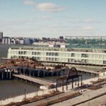 Aerial view of Pier 57 and surrounding area in New York City with the Hudson River in the background.