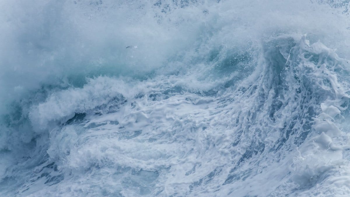 Close-up of powerful ocean waves crashing with intense seafoam and splashes.