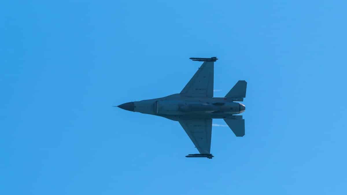An F-16 fighter jet captured mid-flight against a clear blue sky, showcasing military aviation prowess.