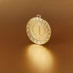 Close-up image of a golden number one medal on a soft golden background.