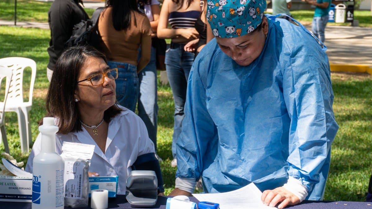 A health professional assists at a community health awareness event in Piura, Peru.