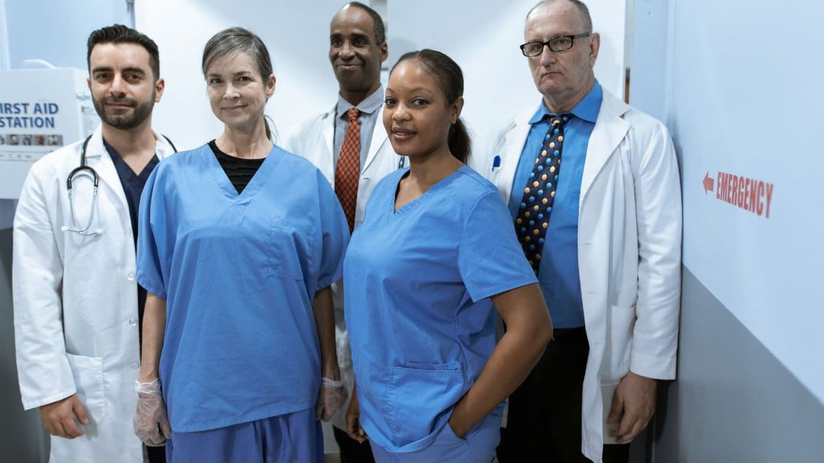 A diverse group of healthcare professionals in hospital uniforms, showcasing teamwork and diversity.