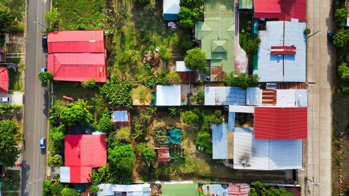 An aerial shot showcasing vibrant rooftops and gardens in a Costa Rican neighborhood.