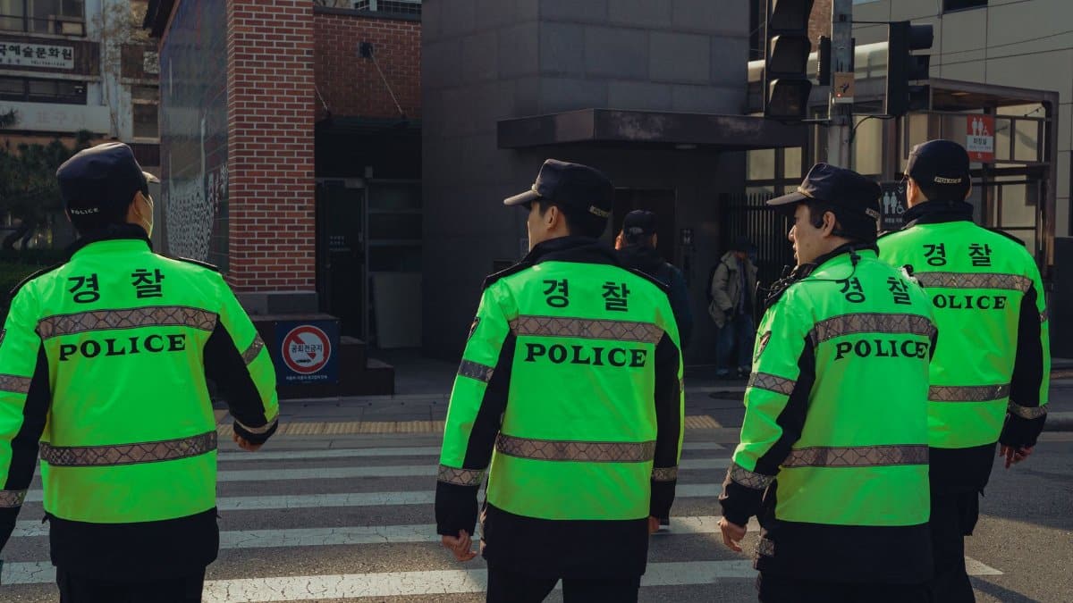 Police officers on duty in Seoul, South Korea, showcasing urban life and safety enforcement.
