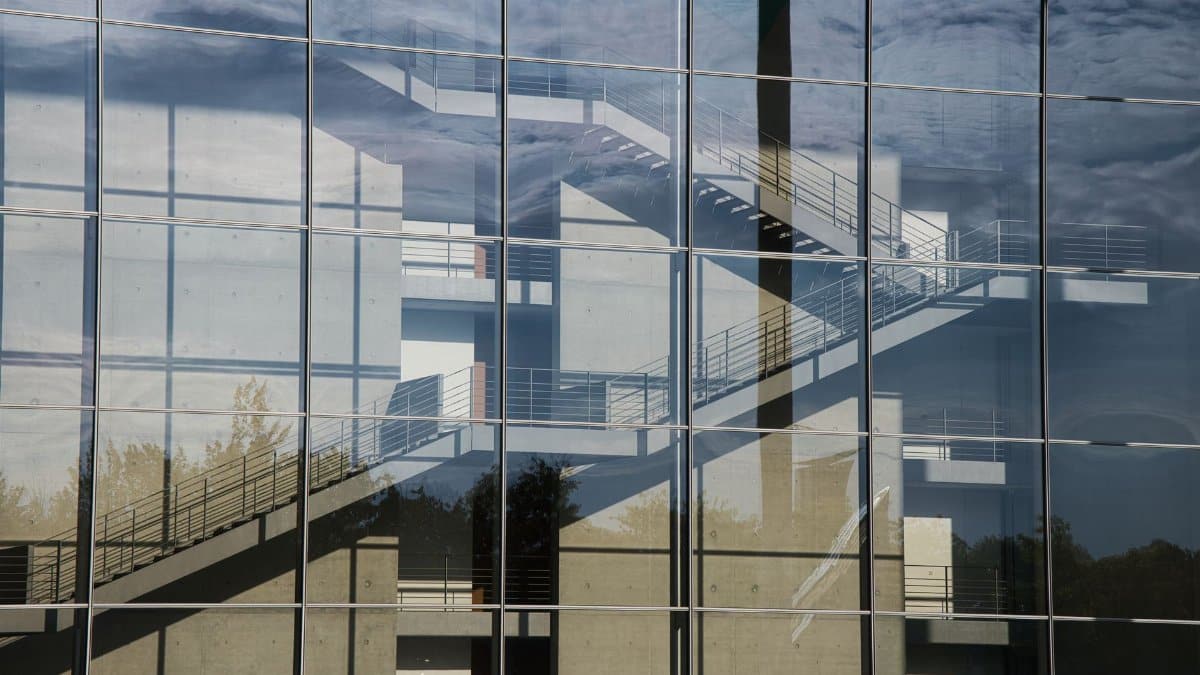Glass facade reflecting a stairwell in Berlin's government district.