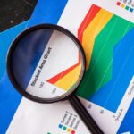 Magnifying glass highlighting stacked area charts for business analysis.