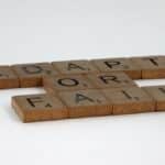 Scrabble tiles spelling 'Adapt or Fail' on a plain background, symbolizing decision-making.