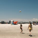 A lively beach volleyball game under a clear sky at Cape May, New Jersey.