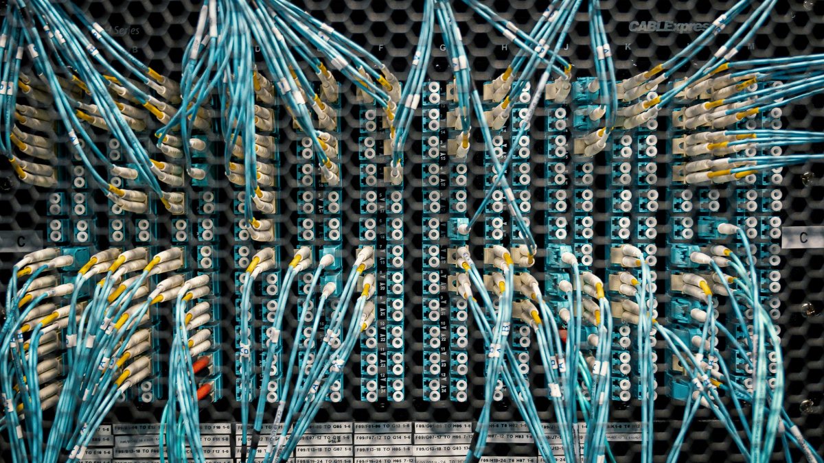 Overhead view of similar bright cables with plastic connectors in fiber optical switch