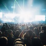 Thrilling live concert experience with a crowd under spectacular laser lights.