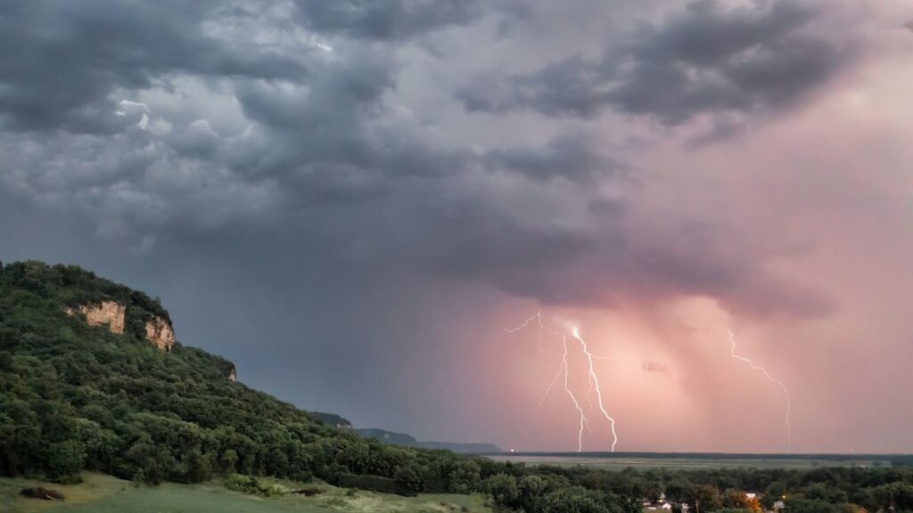Captivating view of a thunderstorm with lightning over rolling hills in Nelson, Wisconsin.