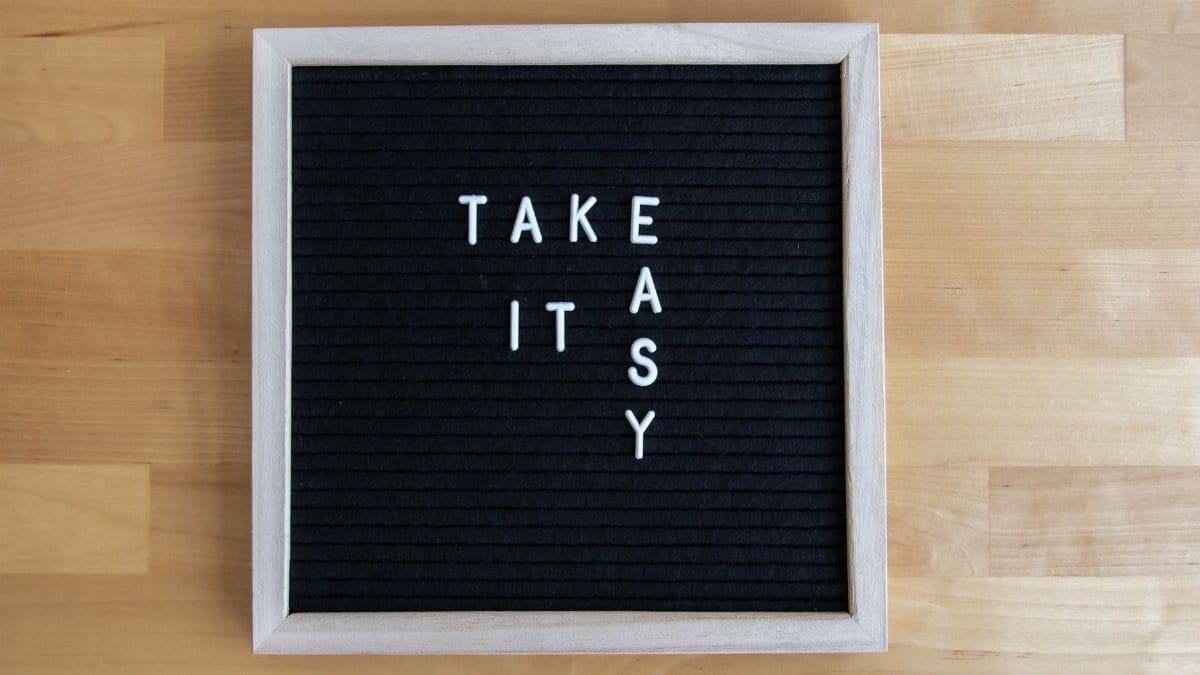 Blackboard sign with 'Take It Easy' message, perfect for relaxation themes.