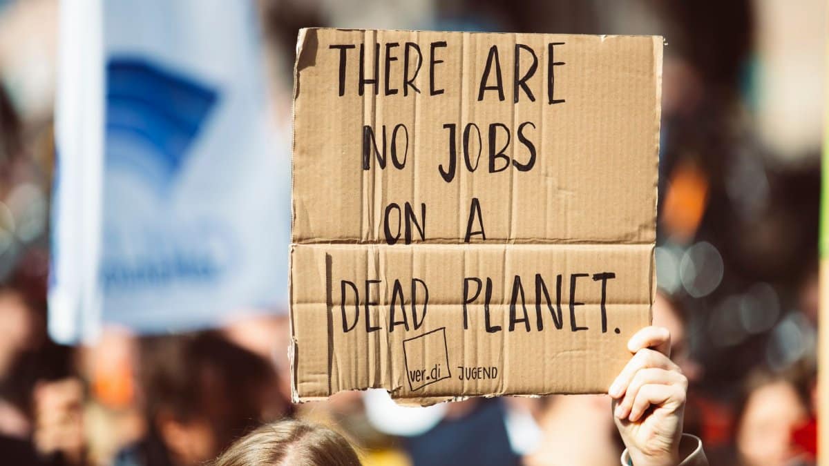 Cardboard sign at climate protest reads 'There are no jobs on a dead planet.'
