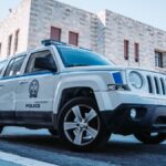 A Greek police car parked on a street in Rodos, Greece, showcasing local architecture.