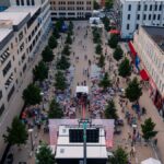 A lively aerial view of a street festival in Chattanooga, Tennessee showcasing vibrant crowds and urban architecture.