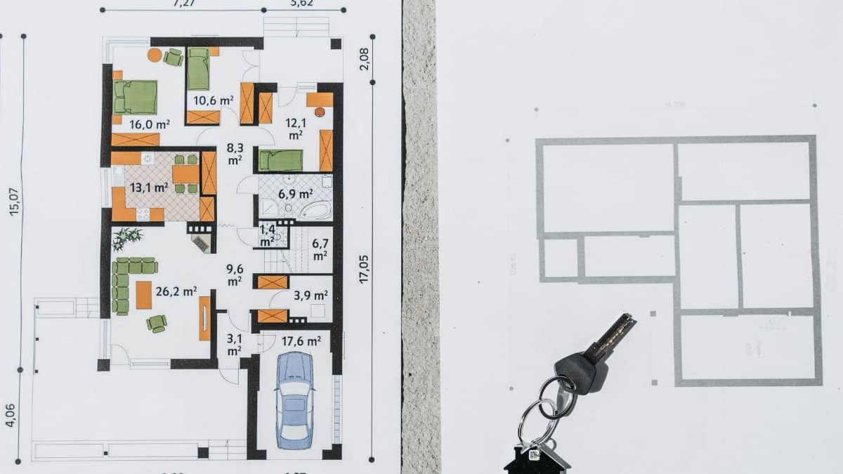A comprehensive floor plan layout featuring a house key symbolizing real estate and homeownership.