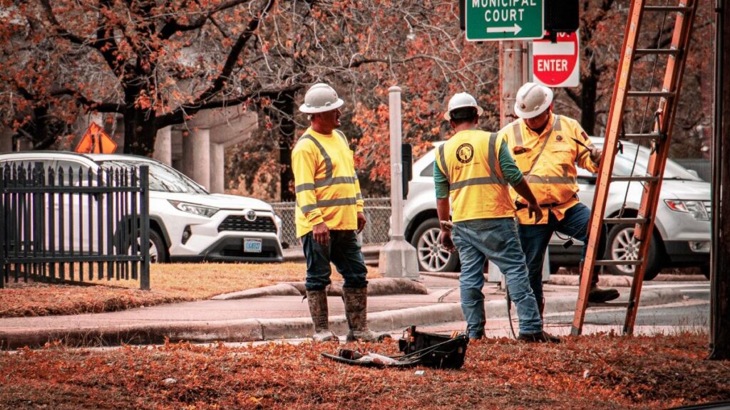 Construction workers in Houston working near the municipal court on a clear day.
