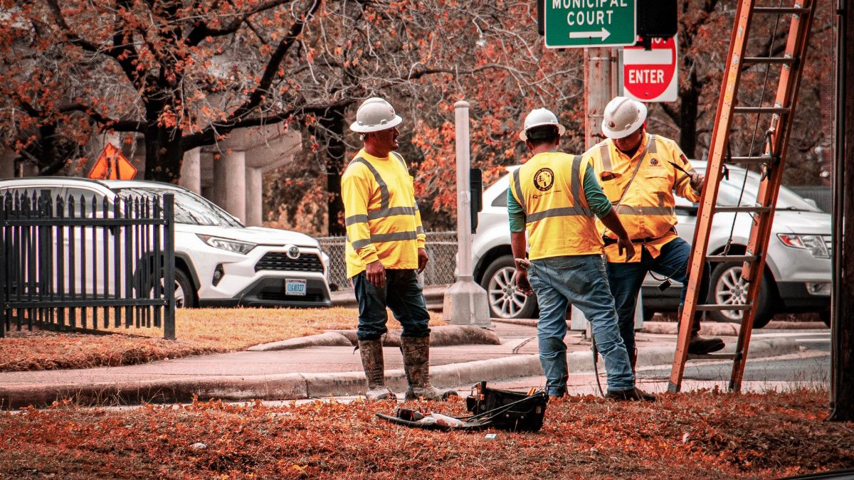 Construction workers in Houston working near the municipal court on a clear day.
