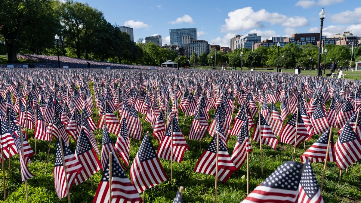 A field of American flags in Boston Common on a clear day, honoring Memorial Day.