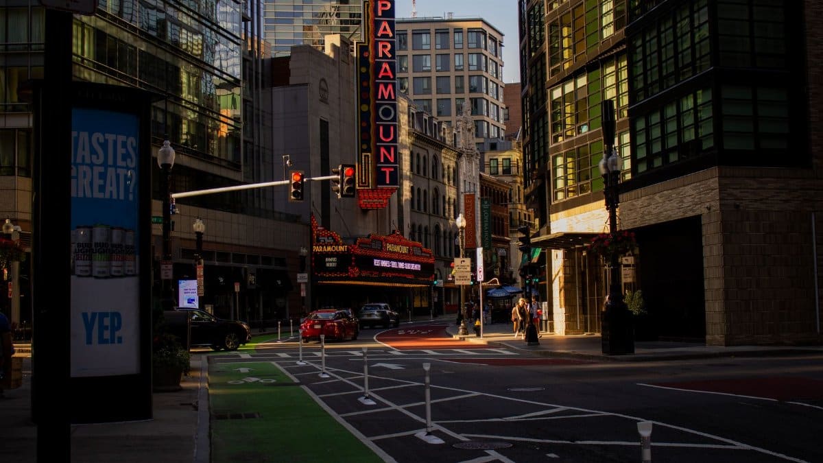 Street view of the iconic Paramount Theater in Boston during daylight with traffic and pedestrians.