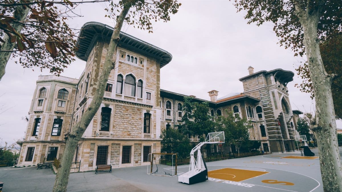 A beautiful historic school in Istanbul with an outdoor basketball court, blending architecture and sports.