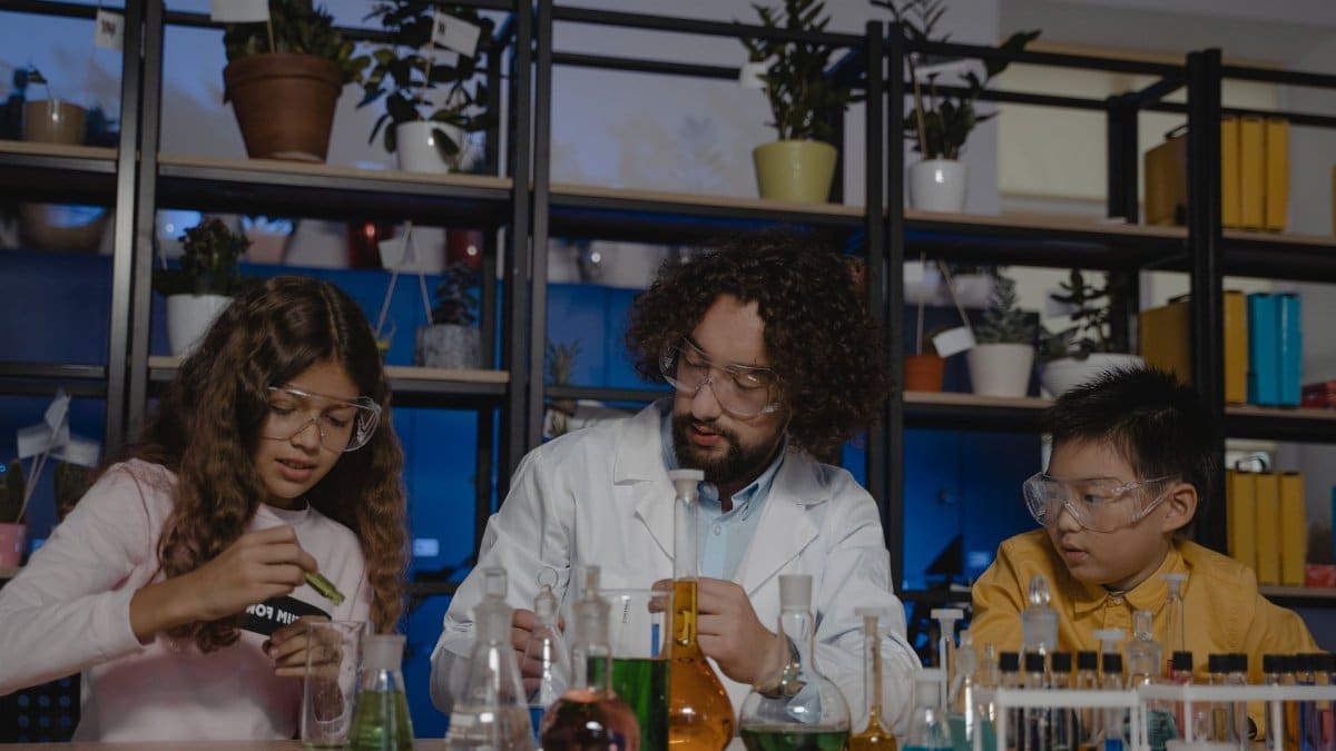 Students and teacher conducting chemistry experiments in a classroom setting.