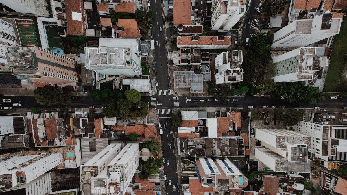 Drone view capturing urban high-rises and roads, showcasing metropolitan life.