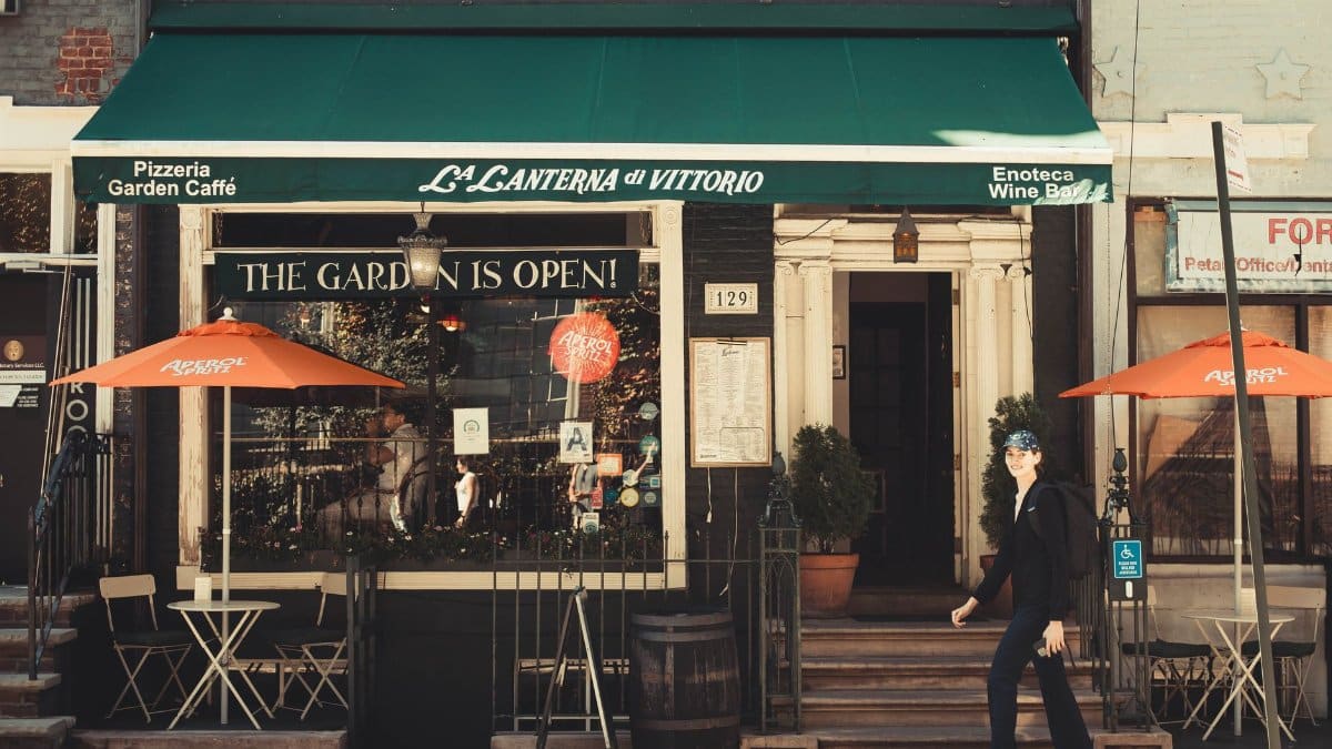 Outside La Lanterna di Vittorio cafe with vibrant umbrellas in New York.