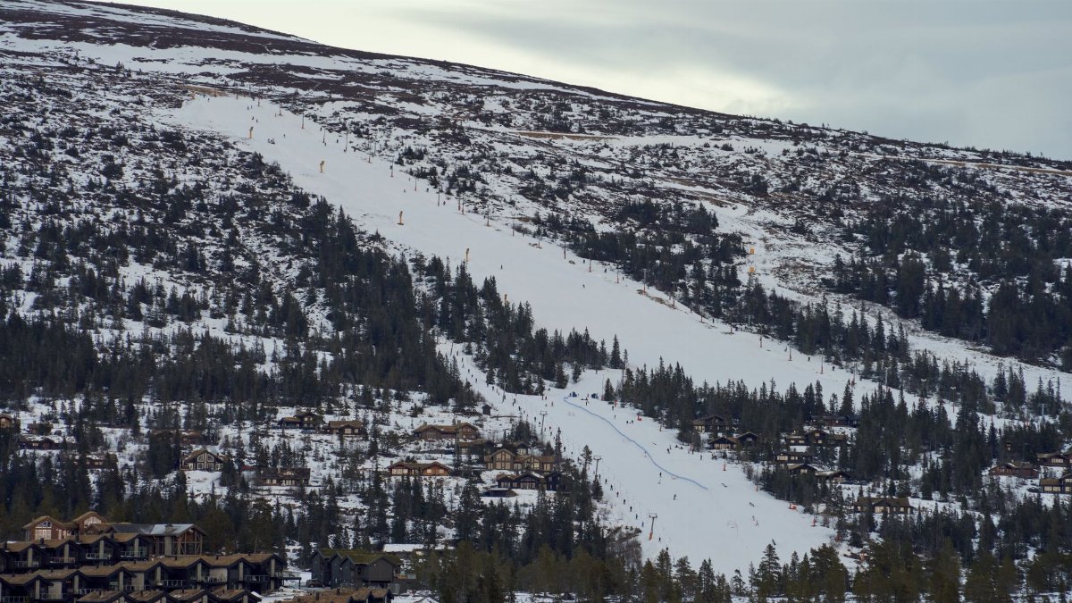 A breathtaking aerial view of the snow-covered Norefjell ski resort in Buskerud, Norway, featuring ski slopes and mountain cabins.