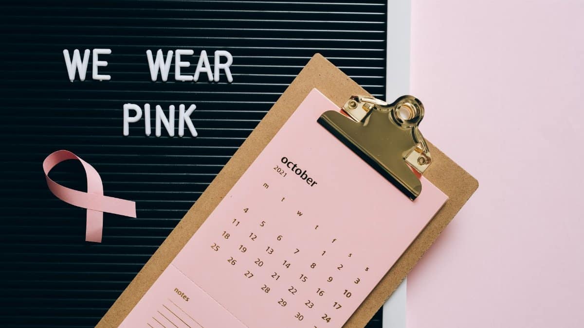 Pink October calendar with ribbon for breast cancer awareness advocacy.