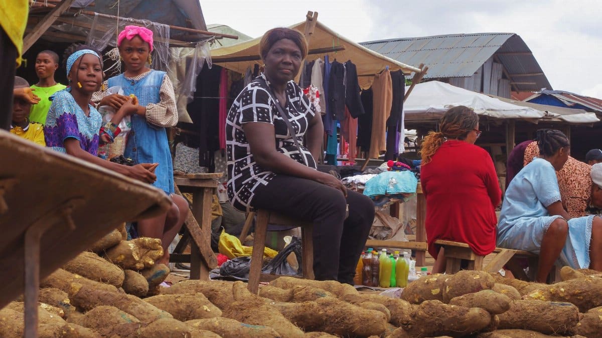 A bustling local market showcasing vendors and customers with fresh produce in Africa.