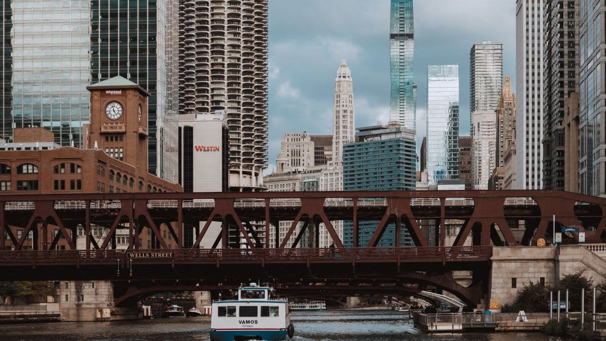 Stunning view of Chicago skyline with Wells Street Bridge and ferry on the river.
