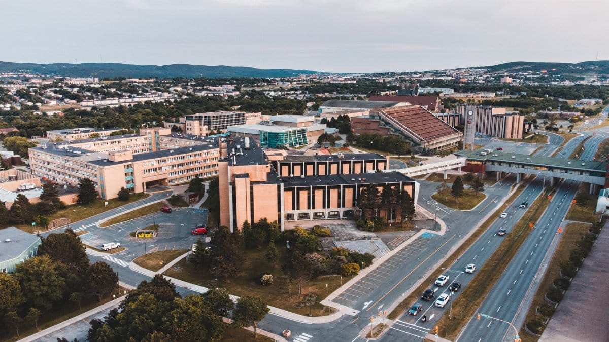 A stunning aerial view of an urban landscape with roads, buildings, and a scenic backdrop.