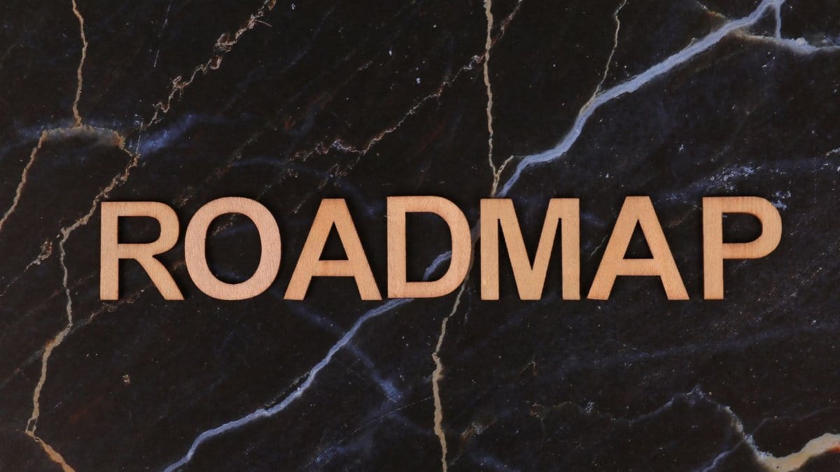 Wooden letters spelling ROADMAP on a dark marble surface, ideal for business presentations.