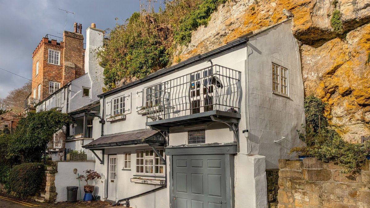 Picturesque house integrated into rock face, Knaresborough, England.