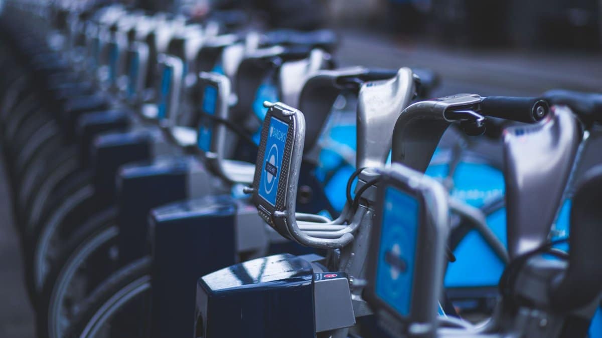 Row of bicycles at a public docking station for urban transportation.
