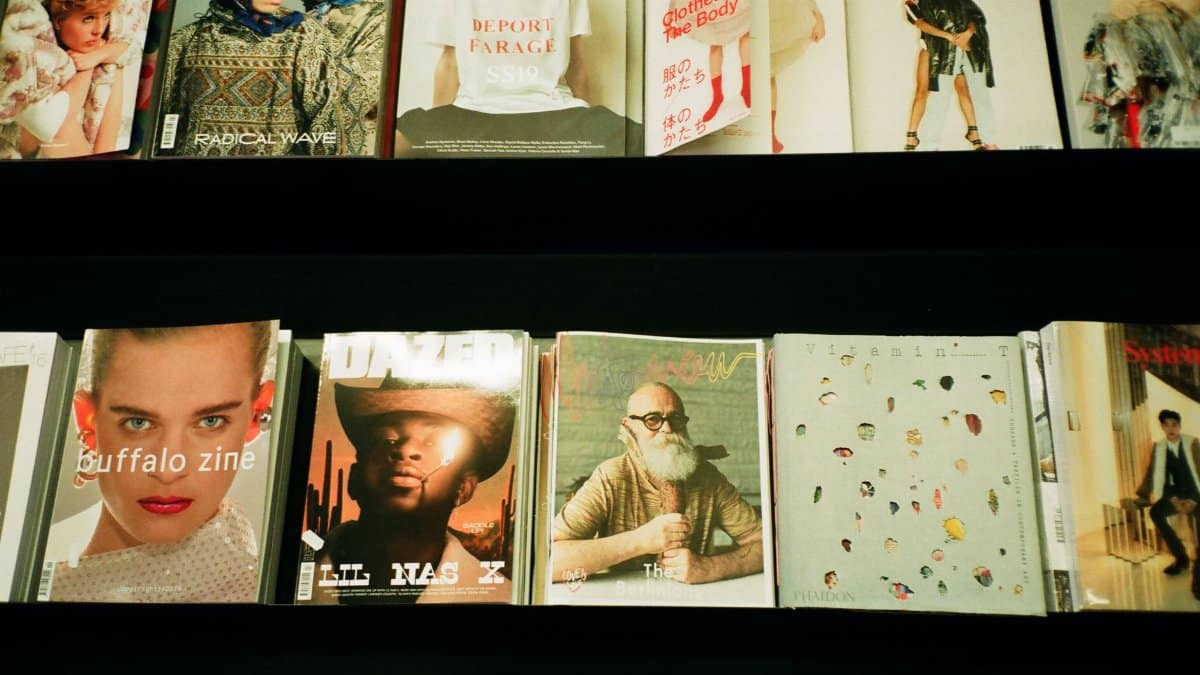 Colorful assortment of fashion magazines displayed on a retail shelf in a bookstore.