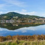 A tranquil lake reflecting hills and sky in Sonoma County, California.