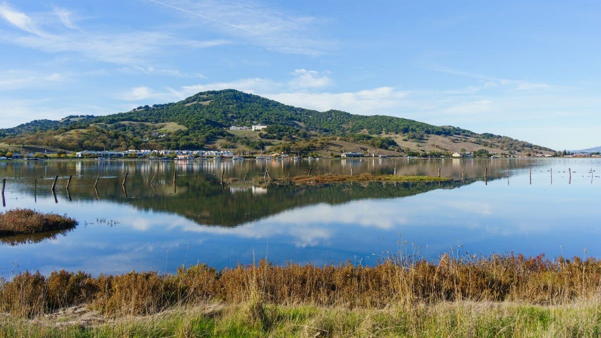 A tranquil lake reflecting hills and sky in Sonoma County, California.