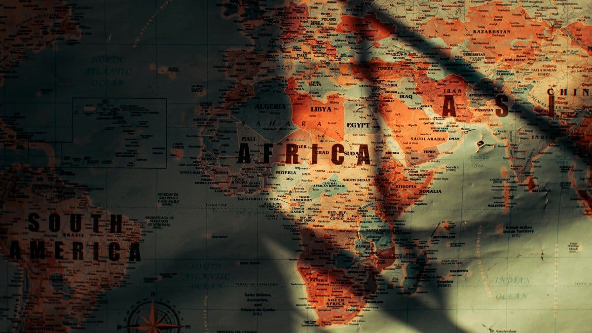 Top view of paper world map with continents and different countries oceans and seas placed in sunny room