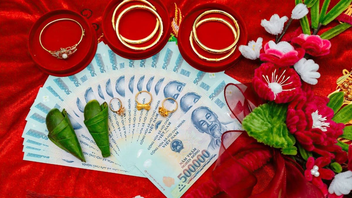A vibrant display of Vietnamese wedding offerings including money, jewelry, and flowers.