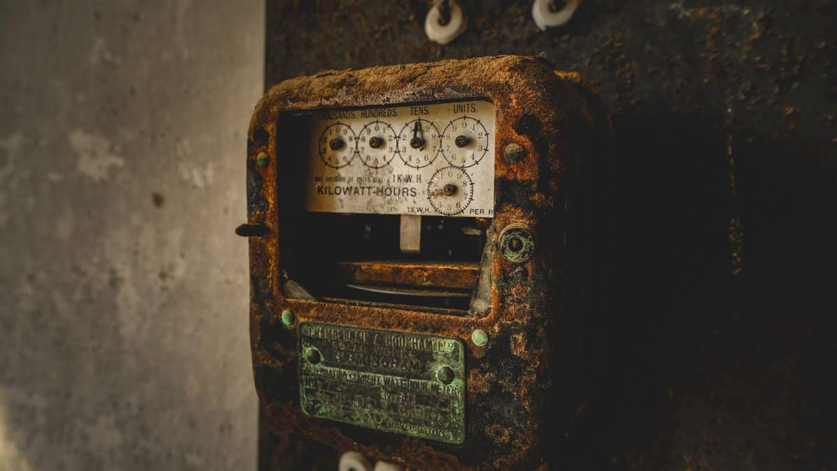 An old, rust-covered kilowatt-hour meter showcasing vintage industrial technology and nostalgia.