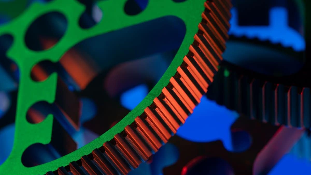 Close-up macro image of vibrant colored gears showcasing precision engineering and industrial mechanics.