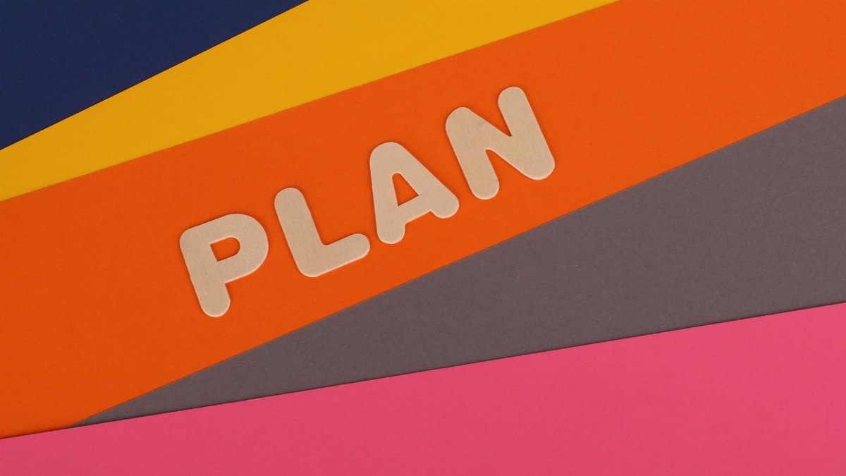 Vibrant geometric colored background with the word 'Plan' in bold letters, perfect for business concepts.
