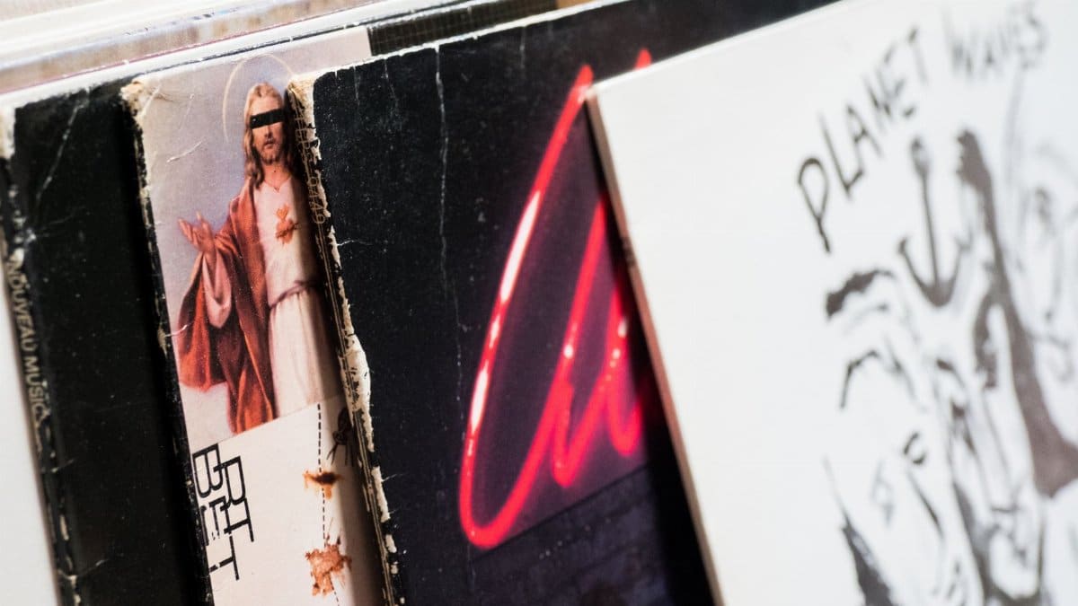 A close-up shot of vintage vinyl records in a shop, showcasing classic album covers.