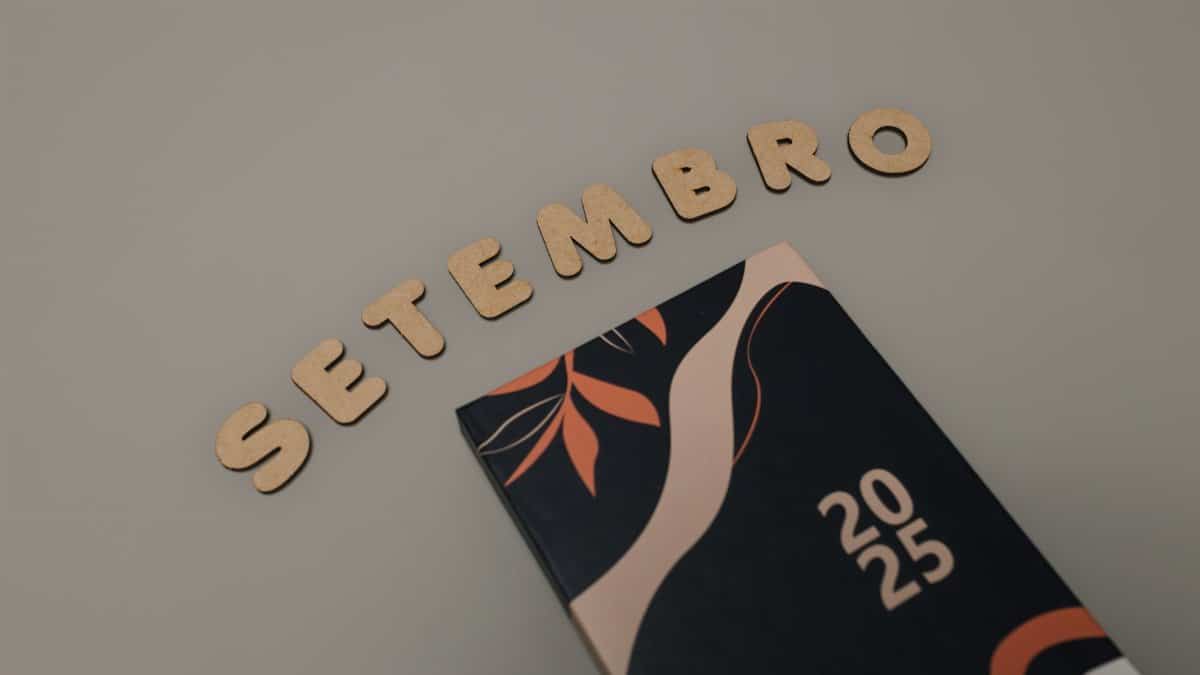 Stylish 2025 planner with abstract cover and 'Setembro' spelled out in wooden letters.