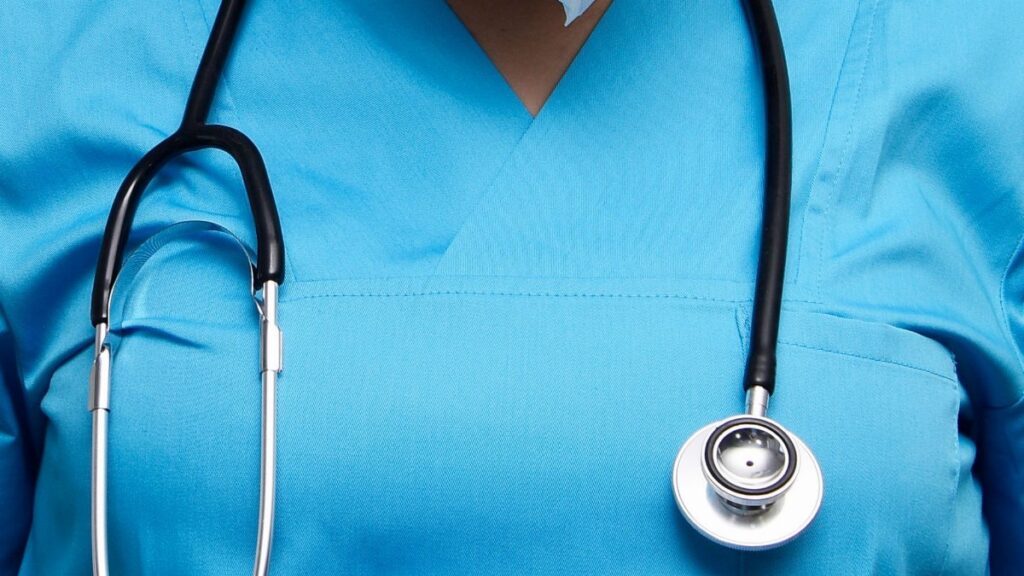 Detailed image of a medical professional wearing scrubs and a stethoscope, symbolizing healthcare.