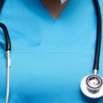 Detailed image of a medical professional wearing scrubs and a stethoscope, symbolizing healthcare.